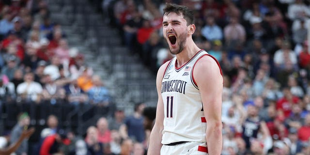 Alex Karaban #11 of the Connecticut Huskies reacts after a touchdown during the first half against the Arkansas Razorbacks in the Sweet 16 round of the NCAA Men's Basketball Tournament at T-Mobile Arena on March 23, 2023 in Las Vegas, Nevada . 