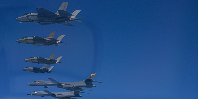 In this photo provided by the South Korean Ministry of Defense, US Air Force B-1B bombers (lower left) fly in formation with South Korean Air Force F-35A and US Air Force F-16 fighter jets ( lower right) over the south.  The Korean Peninsula during a joint air exercise in South Korea, Sunday, March 19, 2023. 