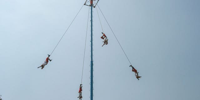 People perform an ancient ritual, Voladores, in Mexico City.