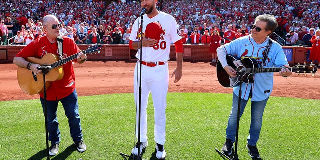 ST. LOUIS, MO - MARCH 30: Adam Wainwright #50 of the St. Louis Cardinals sings the national anthem prior to the game between the Toronto Blue Jays and the St. Louis Cardinals at Busch Stadium on Thursday, March 30, 2023 in St. Louis, Missouri.