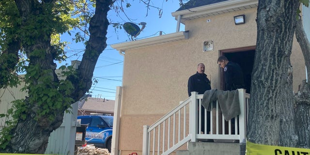 Police stand at the scene of an overnight fire that severely damaged a building that was being renovated to house a new abortion clinic in Casper, Wyoming, on May 25, 2022.