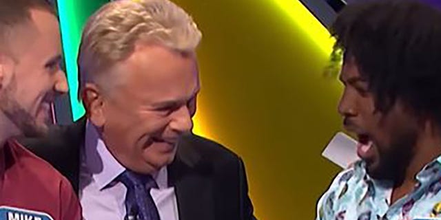 Pat Sajak teased pro wrestler Xavier Woods that he was "trouble" after his giggling.