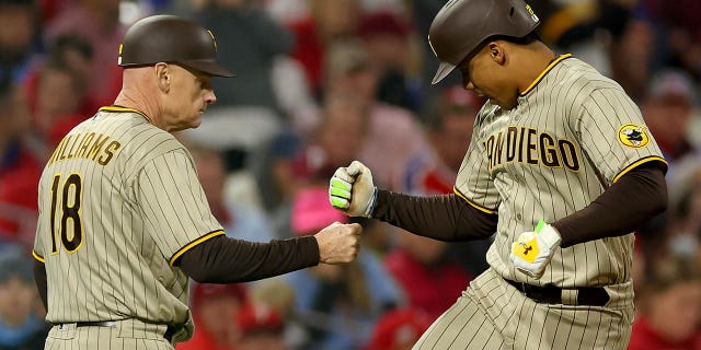 Juan Soto #22 of the San Diego Padres reacts after his two-run home run with third base coach Matt Williams #18 during the fifth inning against the Philadelphia Phillies in game four of the National League Championship Series at Citizens Bank Park on October 22, 2022 in Philadelphia, Pennsylvania.