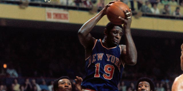Willis Reed #19 of the New York Knicks pulls down the rebound during the Eastern Conference Finals played in 1973 at the Boston Garden in Boston, Massachussetts.