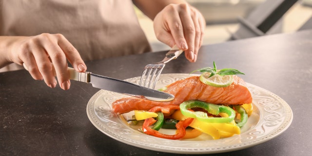 Woman eating salmon