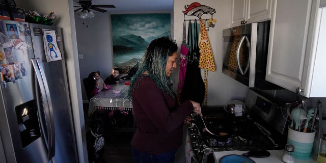 Betty Rivas prepares breakfast for her family on Feb. 23, 2023, in Commerce City, Colorado. Rivas was startled by a letter telling her that the drinking fountains her 8-year-old used at school weren't safe.