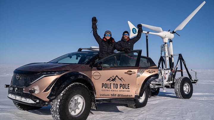 Married couple driving from North Pole to South Pole