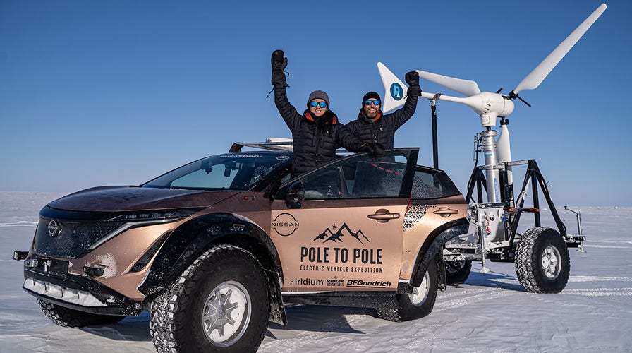 Married couple driving from North Pole to South Pole