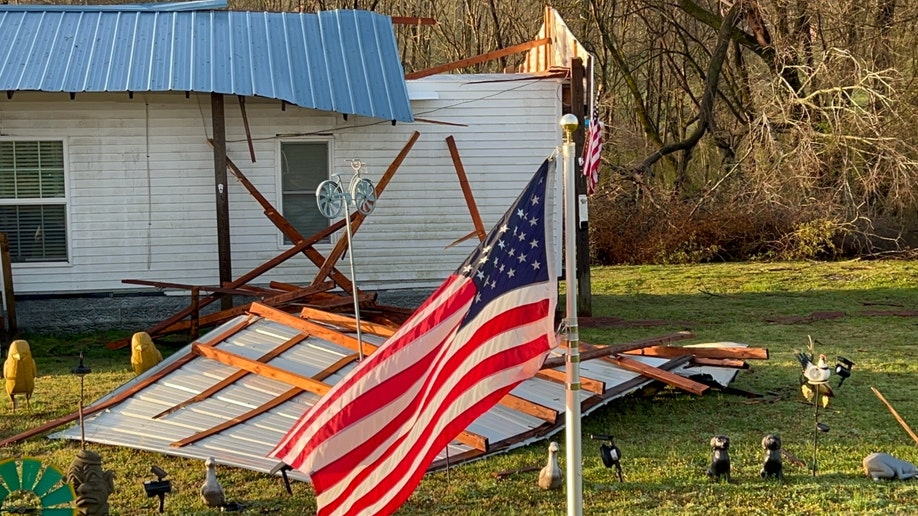 An American flag in storm wreckage in a front yard in Tennessee