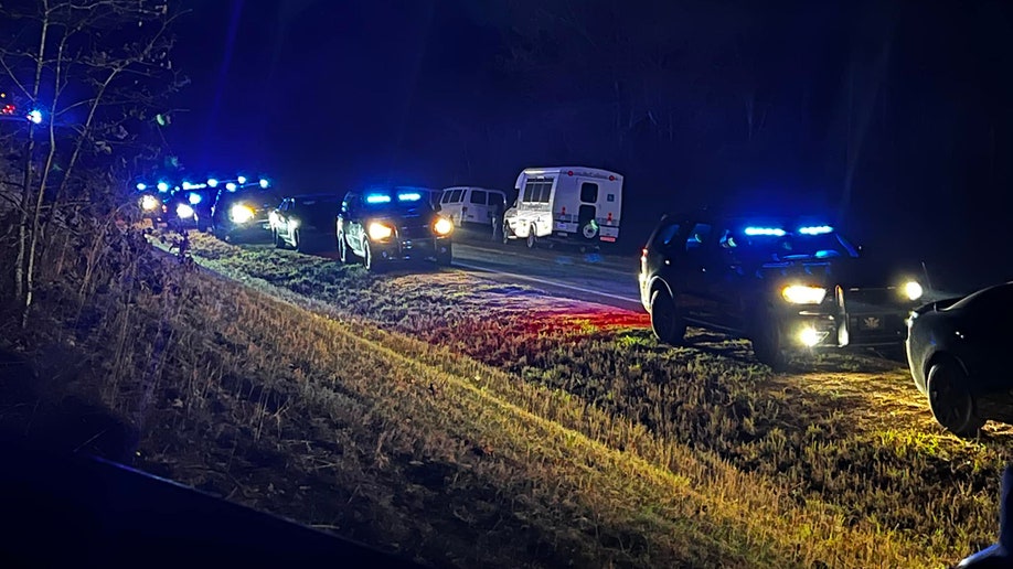 authorities searching for Knight along a road at night
