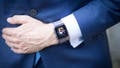 Mans wears Apple watch with suit