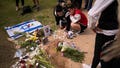 People gather and lay flowers at the site where Alessandro Parini, an Italian tourist, was killed in a Palestinian attack, in Tel Aviv, Israel, Saturday, April 8, 2023. Israeli authorities said an Italian tourist was killed and five other Italian and British citizens were wounded Friday when a car rammed into a group of tourists in Tel Aviv.