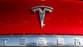 The Tesla company logo sits on an unsold 2020 Model X at a Tesla dealership in Littleton, Colorado, on Feb. 2, 2020.