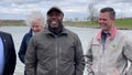 Republican Sen. Tim Scott of South Carolina, with Rep. Zach Nunn of Iowa (right), speak with reporters at a farm in Cumming, Iowa, on April 22, 2023