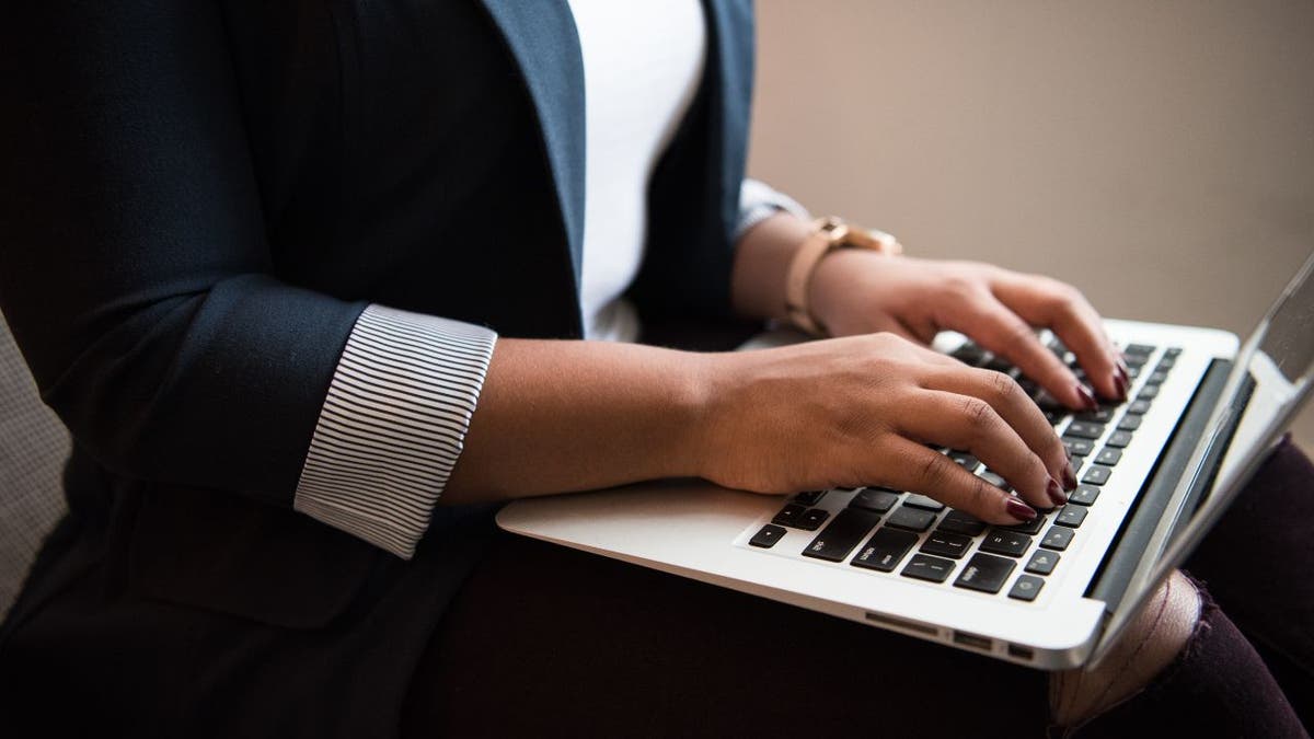 person typing on laptop keyboard