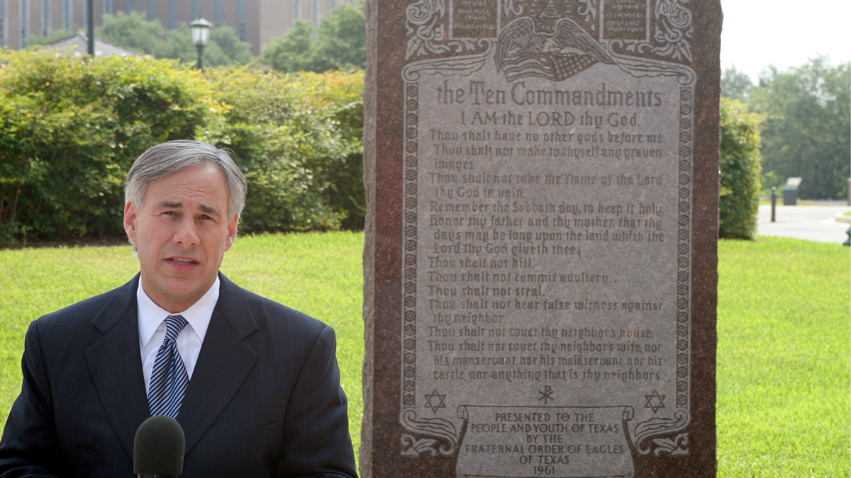 Gov. Abbott next to 10 Commandments plaque