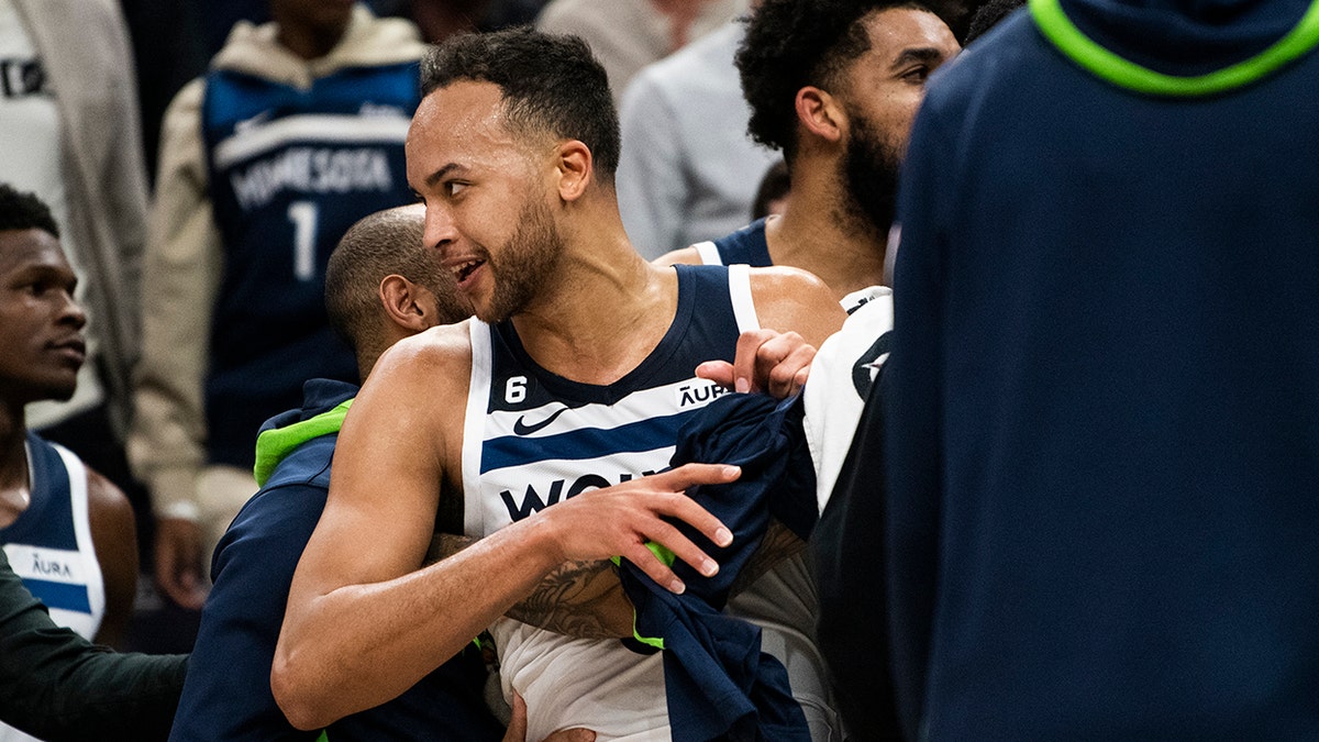 Kyle Anderson held back by teammates