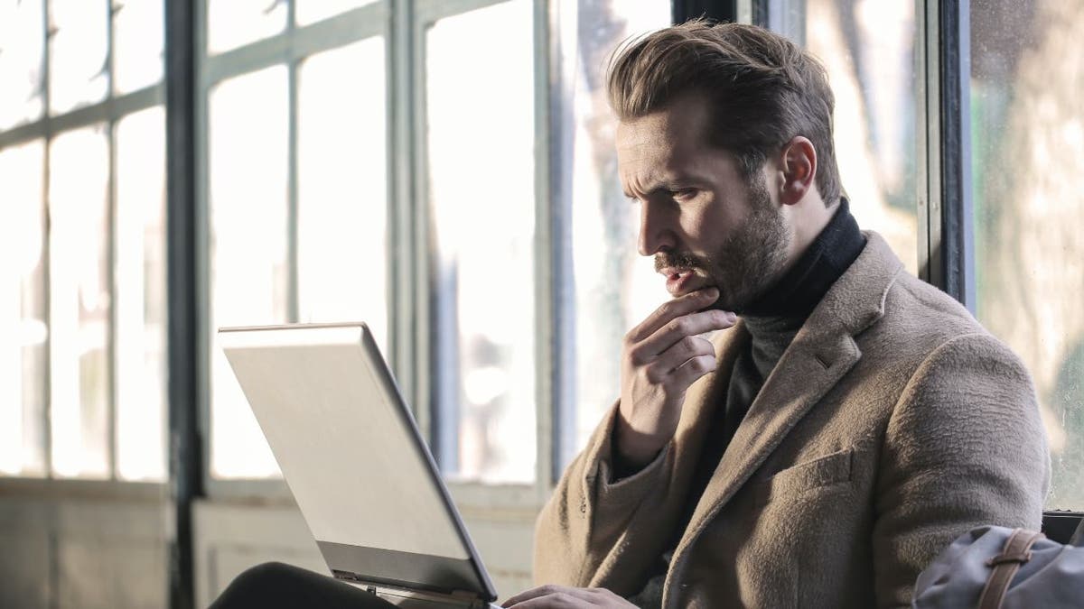 Man looks stressed while at his computer