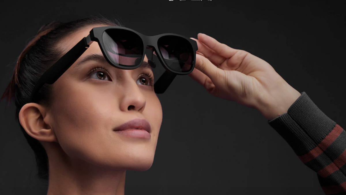 Woman lifts black sunglasses