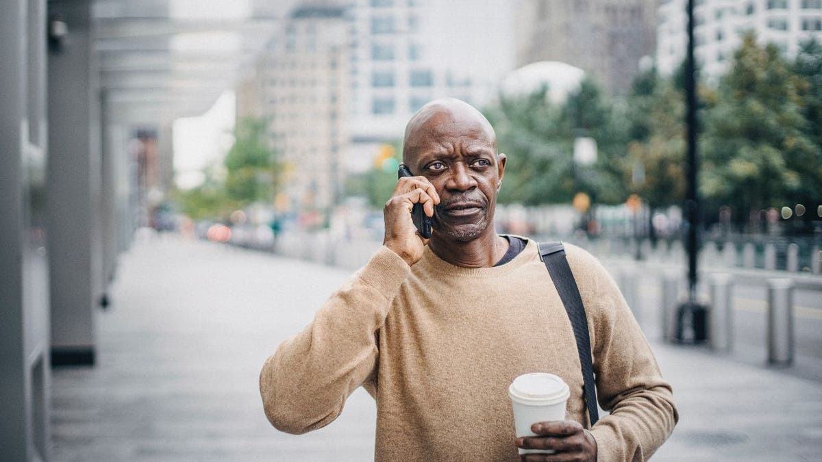 Man on the phone, walking down the street.