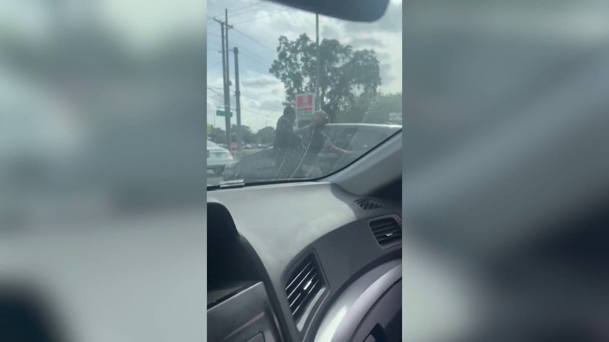 In video posted by the Florida Highway Patrol, the man can be heard yelling "get out of the car!" and the woman can be seen punching the car's window.