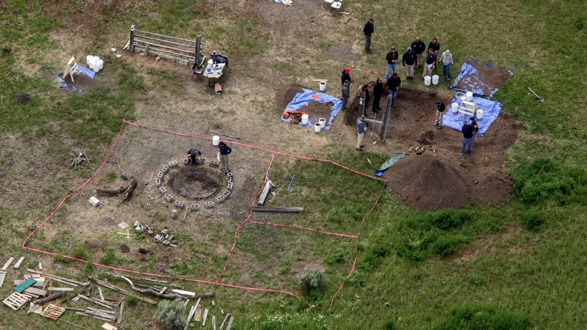 In this aerial photo, investigators search for human remains at Chad Daybell's residence in Salem, Idaho, on June 9, 2020. A mother charged with murder in the deaths of her two children is set to stand trial in Idaho.