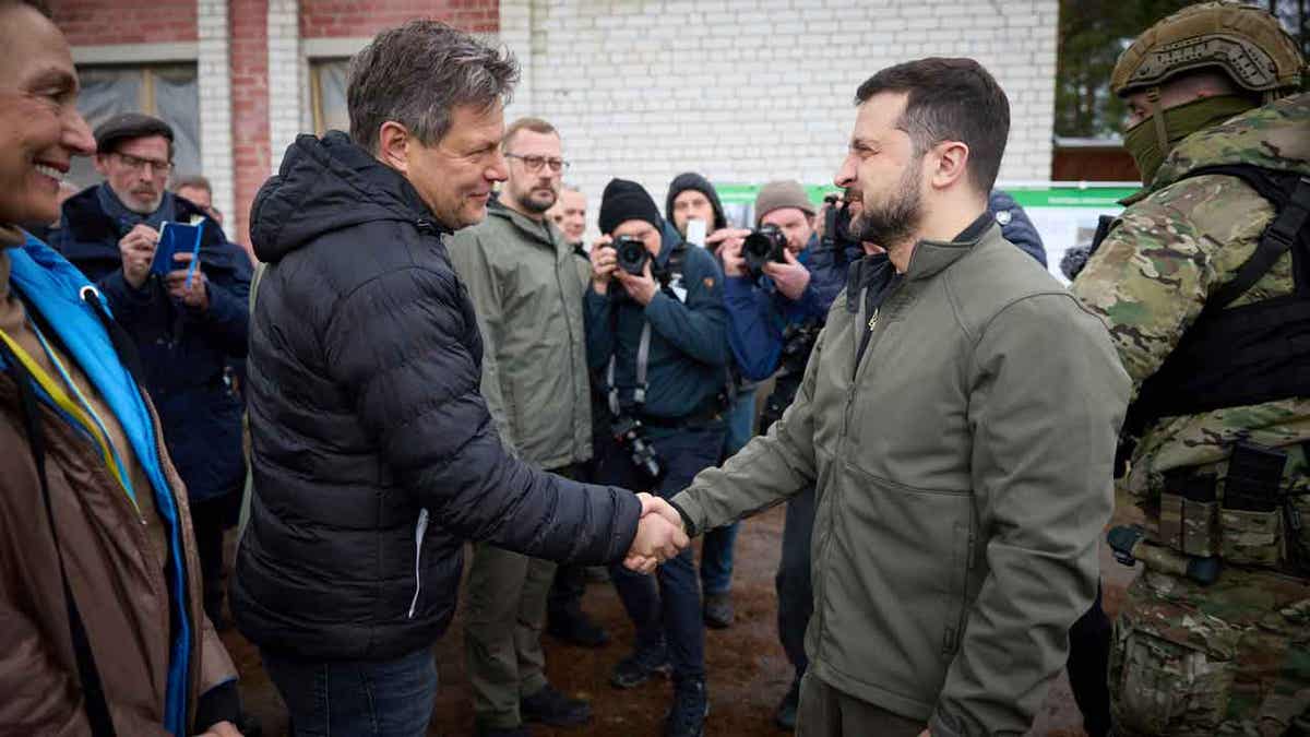 Ukrainian President Volodymyr Zelenskyy, right, shakes hands with German economy and climate minister Robert Habeck in the Chernihiv region of Ukraine, on April 3, 2023. Olaf Scholz's spokesman on April 5, 2023, defended his country's record on delivering arms to Ukraine after Habeck, a pre-war advocate of providing Ukraine with arms, said this week he was "deeply ashamed" that it took Germany so long to do so.