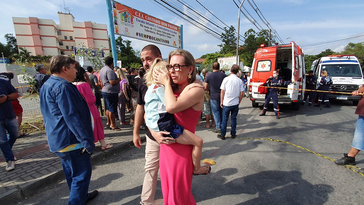 Brazil parent clutches child after day care attack