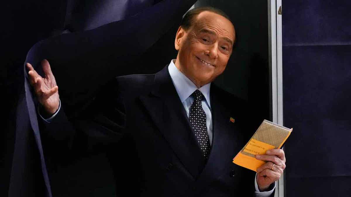 Silvio Berlusconi comes out of a voting booth before casting his ballot at a polling station in Milan, Italy, on Sept. 25, 2022. Berlusconi's health is improving after being hospitalized last Wednesday. 