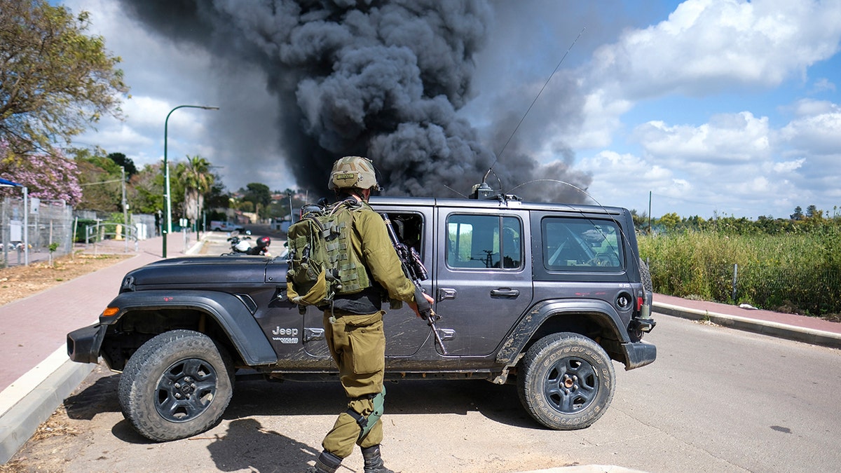 A soldier and a smoke plume