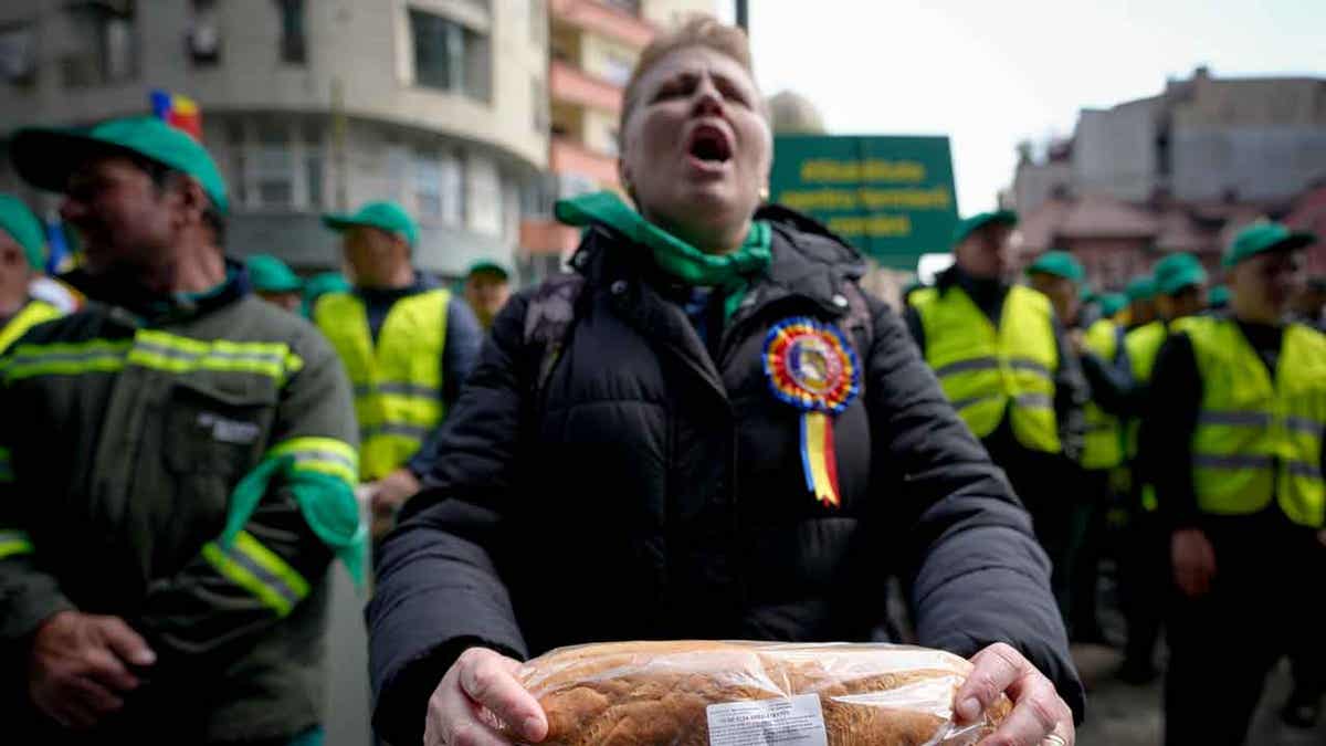 A woman holds a loaf of bread