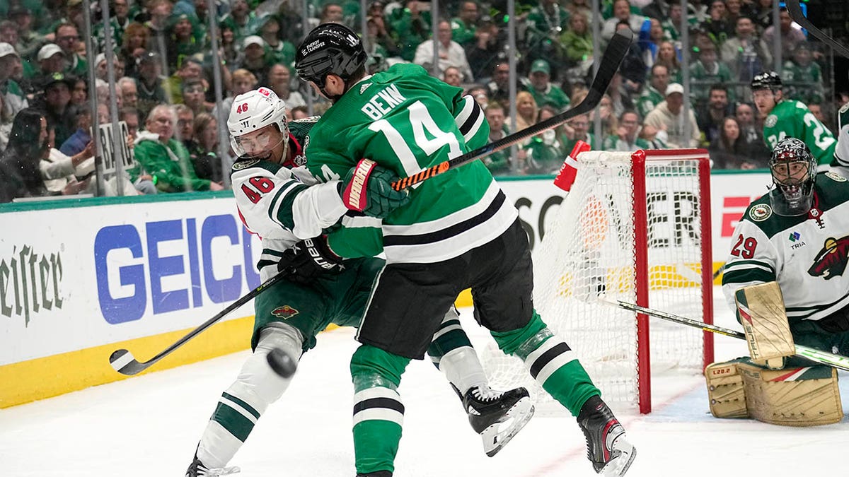 Jared Spurgeon takes a hit from Jamie Benn