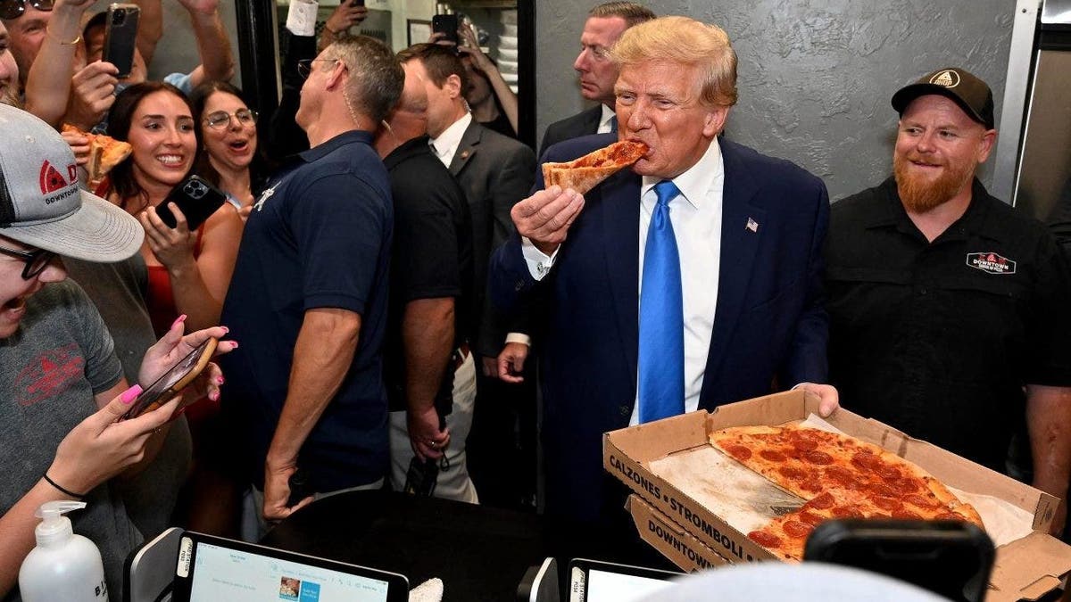 Trump eating slice of pizza
