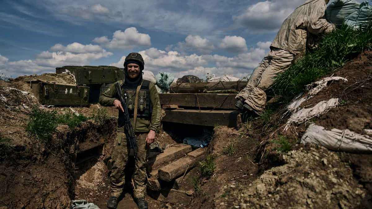 A Ukrainian soldier smiles 