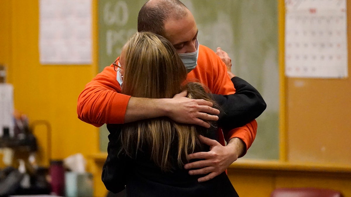 Nima Momeni, right, hugs his attorney, Paula Canny