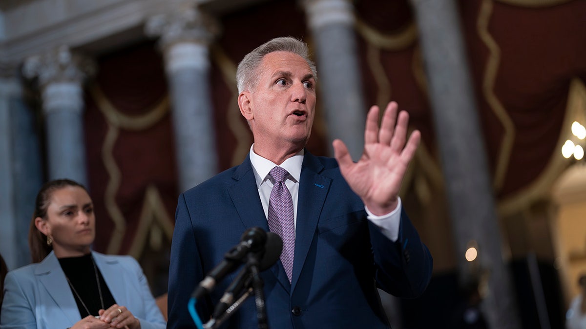 House Speaker Kevin McCarthy speaking with his hand up
