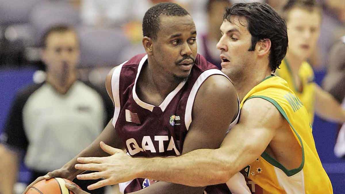 Qatar's Hashim Zaidan, left, and Australia's Sam Mackinnon are shown playing basketball during the first round Group C match at the World Basketball Championships in Hamamatsu, Japan, on Aug. 24, 2006. The International Basketball Federation has picked Qatar to host the 2027 edition of its men’s World Cup. 