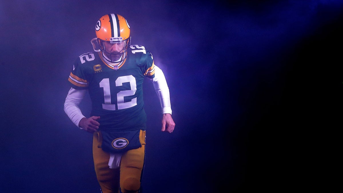 Aaron Rodgers runs on the field