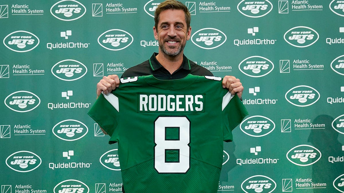 Aaron Rodgers displays Jets jersey