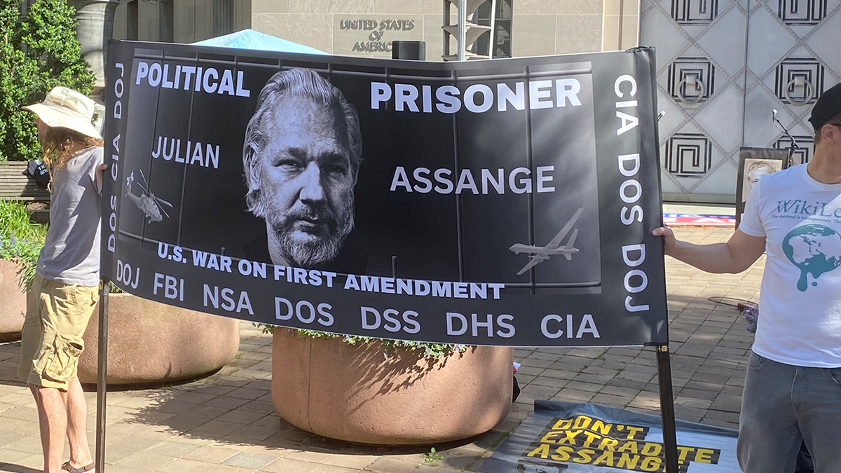 Julian Assange poster at DOJ rally