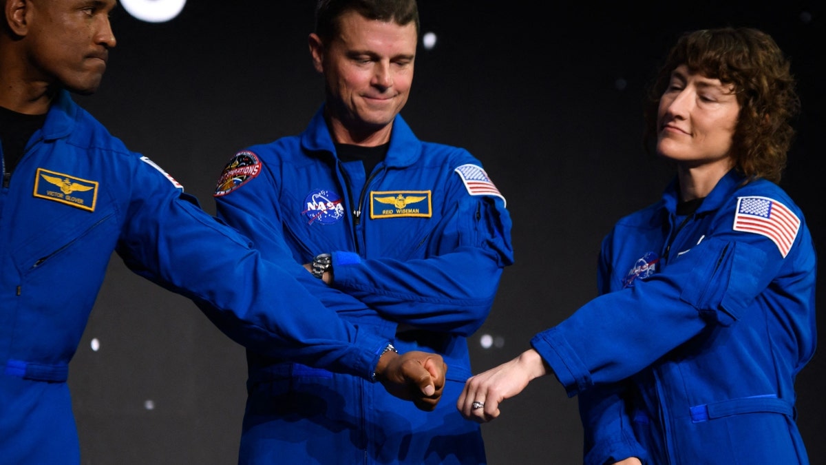 Astronauts Christina Hammock Koch (R), Victor Glover (L) and Jeremy Hansen react