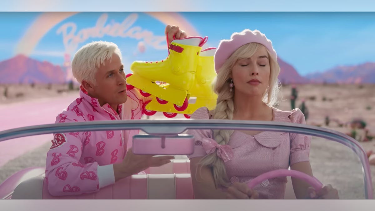 Ryan Gosling as Ken and Margot Robbie as Barbie driving pink car