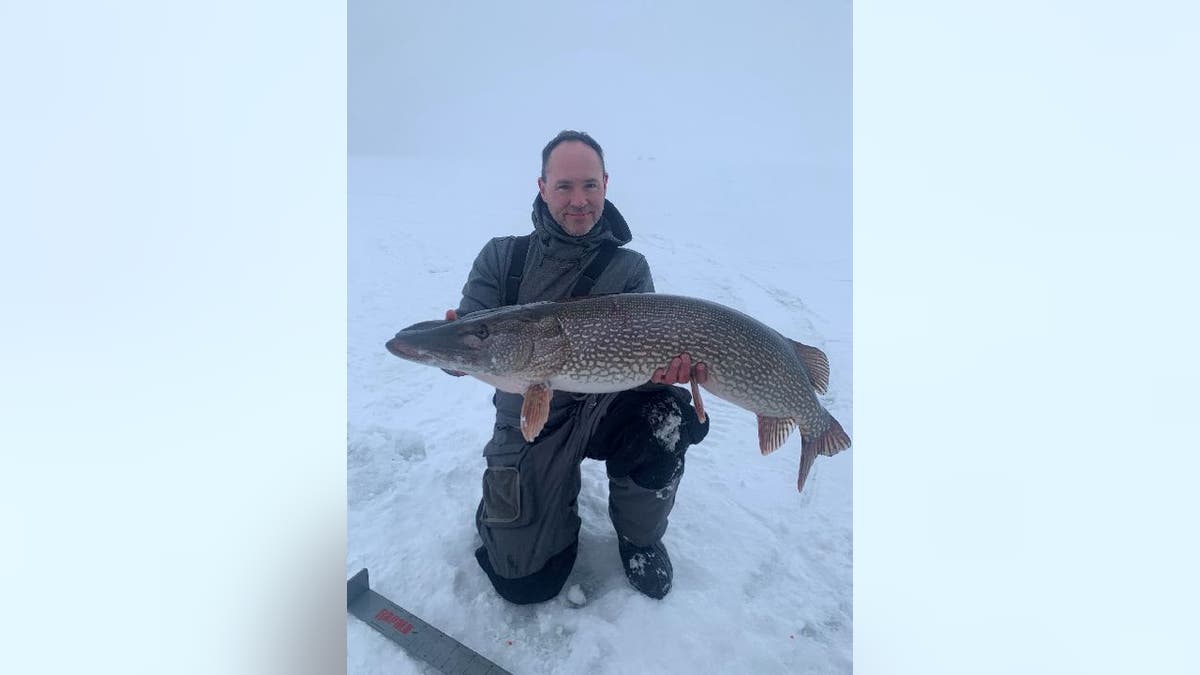 Brad Lila holds up northern pike