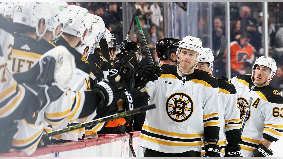 Charlie Coyle fist bumps teammates