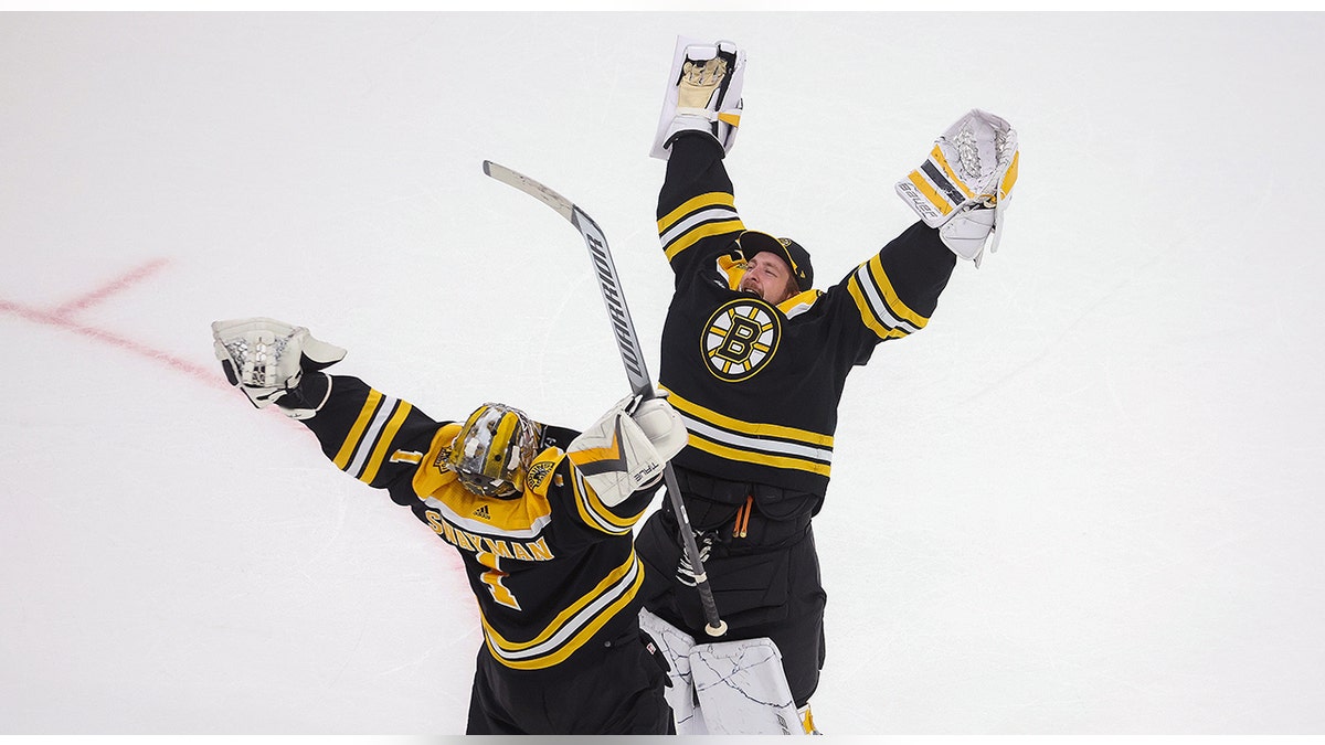 Jeremy Swayman and Linus Ullmark celebrate win