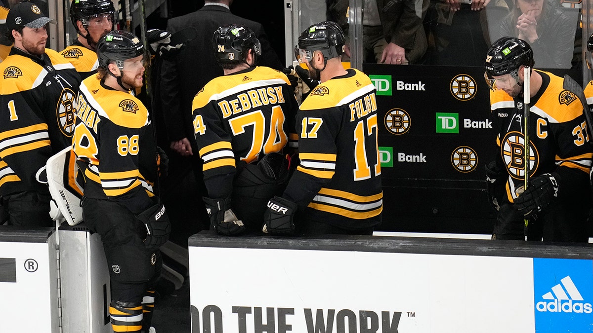 Bruins players walk off the ice