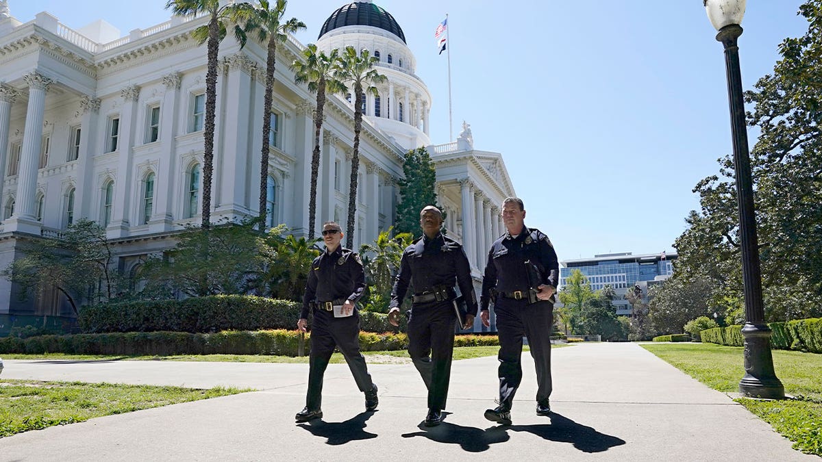 Police walk past CA Capitol