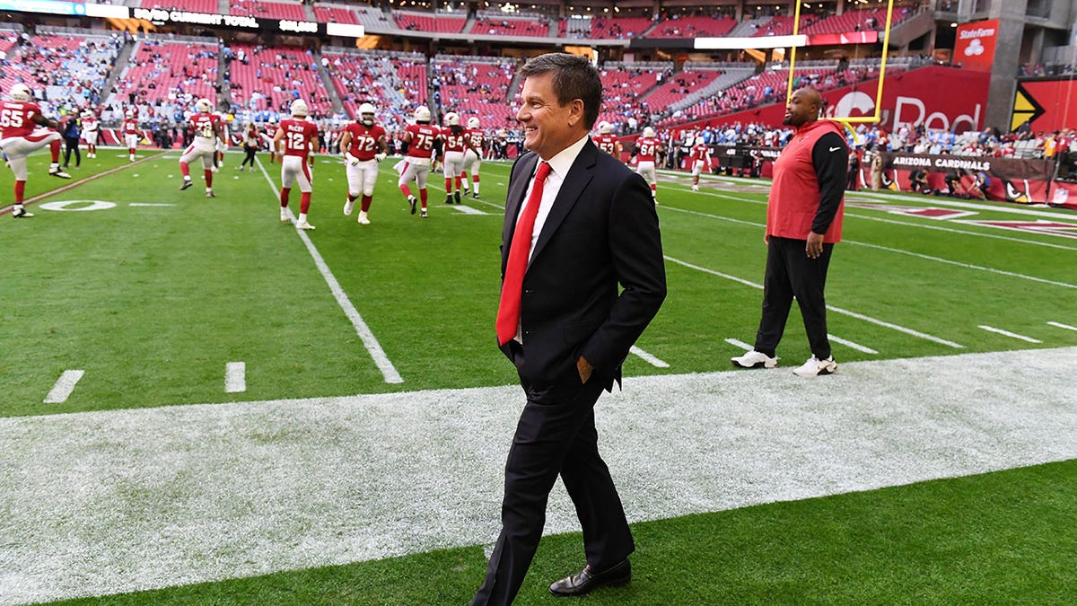 Michael Bidwill walks along the sidelines