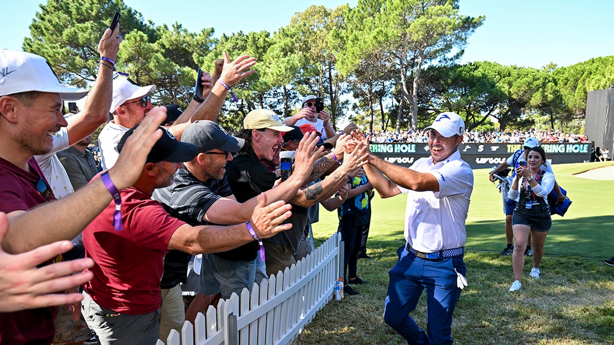 Chase Koepka high-fives fans
