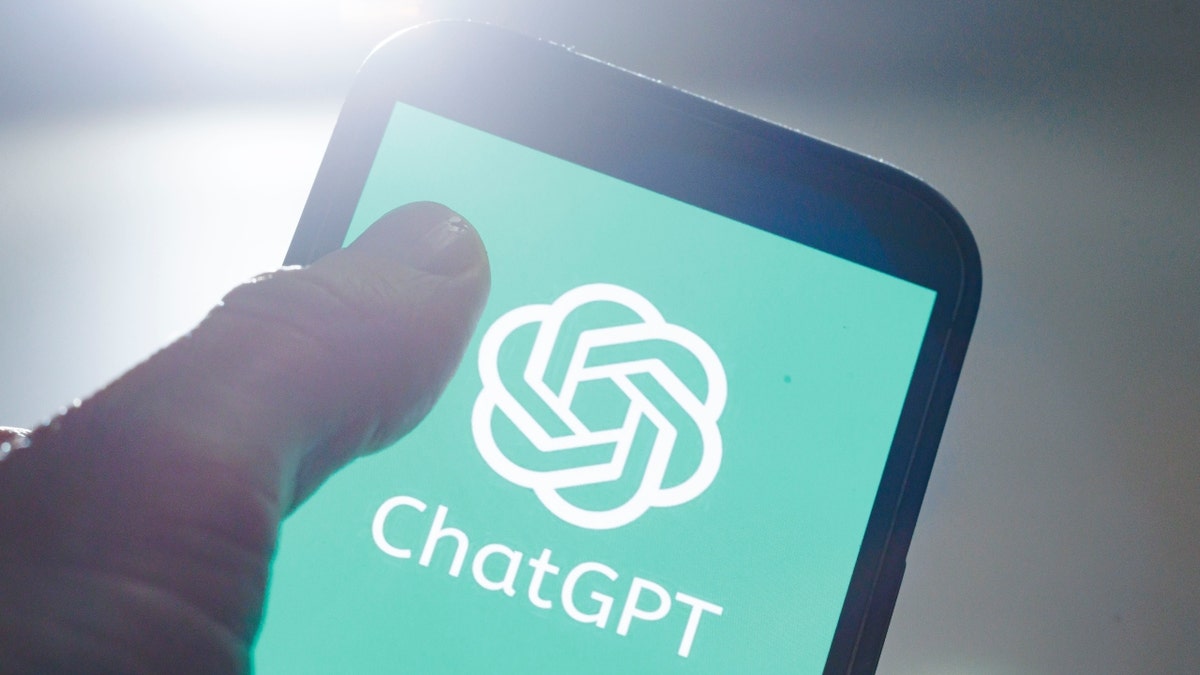 ChatGPT on a smart phone with man's thumb